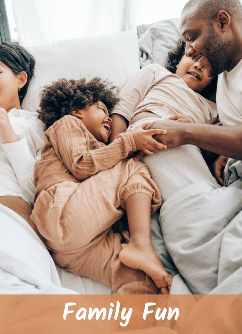 Family members are lying on hotel bed