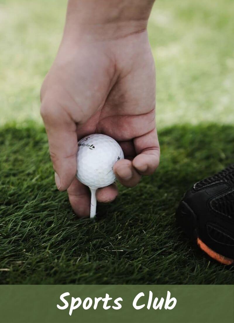 A men is putting golf ball in right position