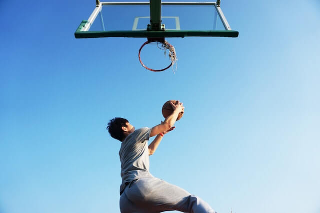 A boy is playing Basketball