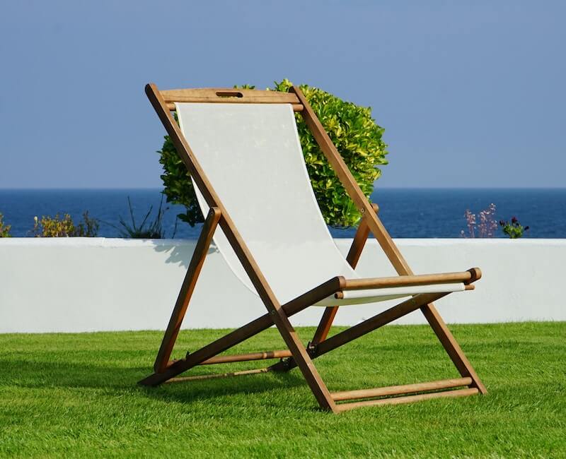 A empty chair besides the beach