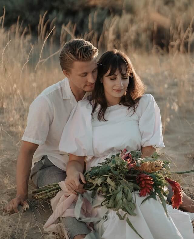 Two cuples are sitting on soil